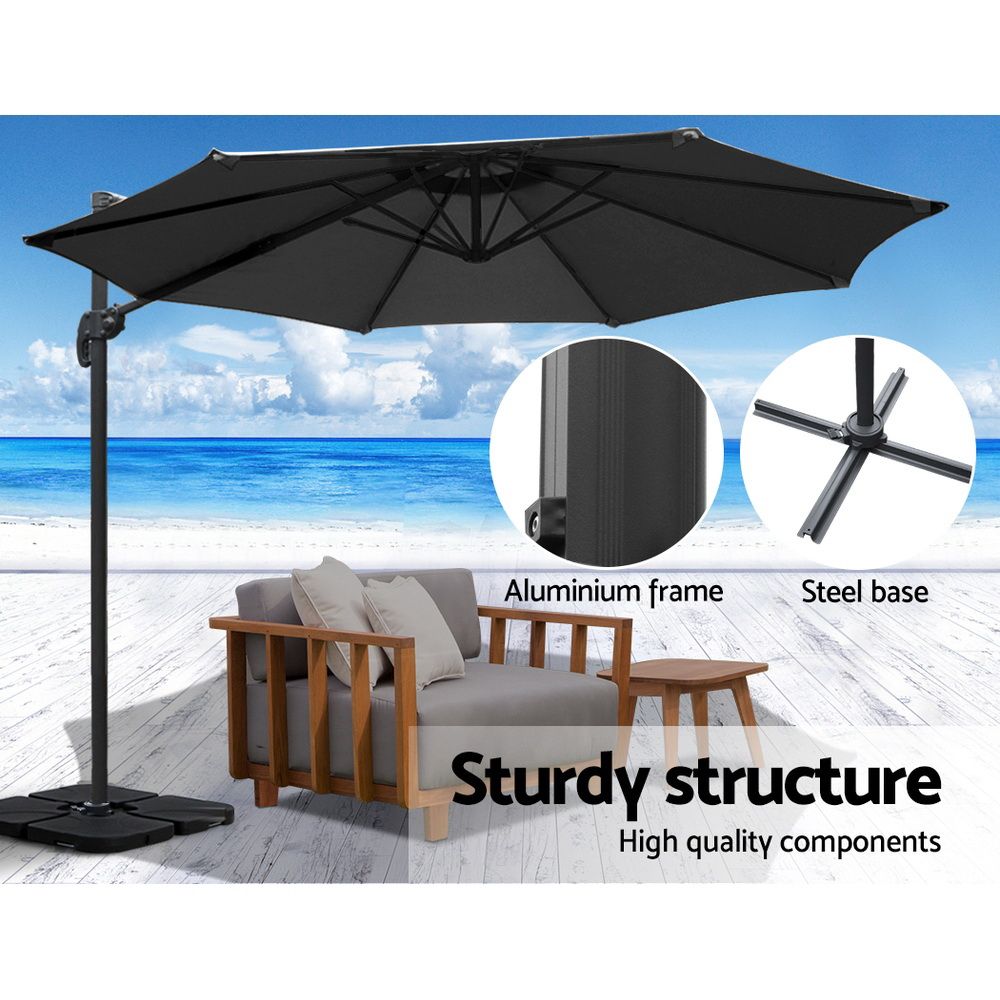 Black cantilever umbrella with aluminum frame and steel weighted base, side view
