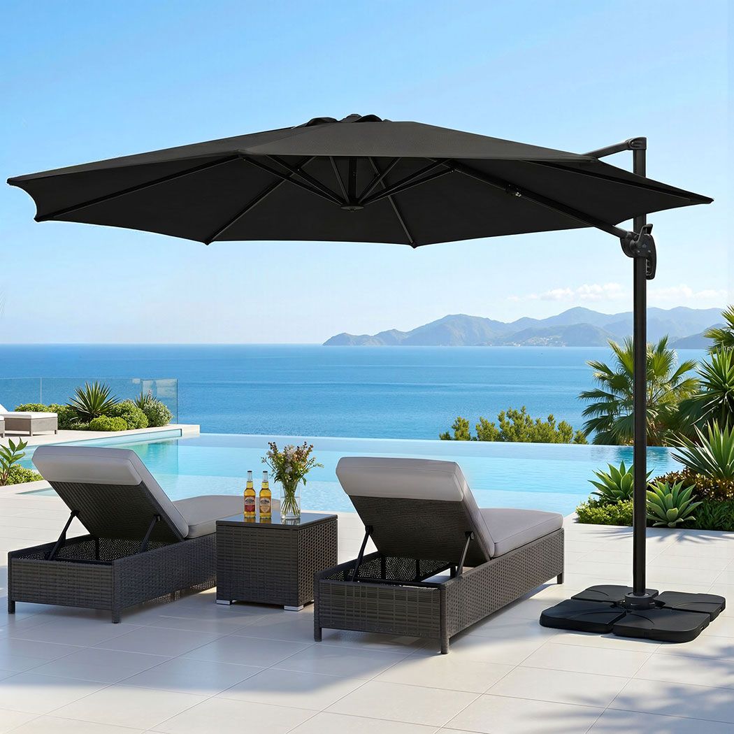 Black cantilever patio umbrella with square weighted base and open tilt canopy