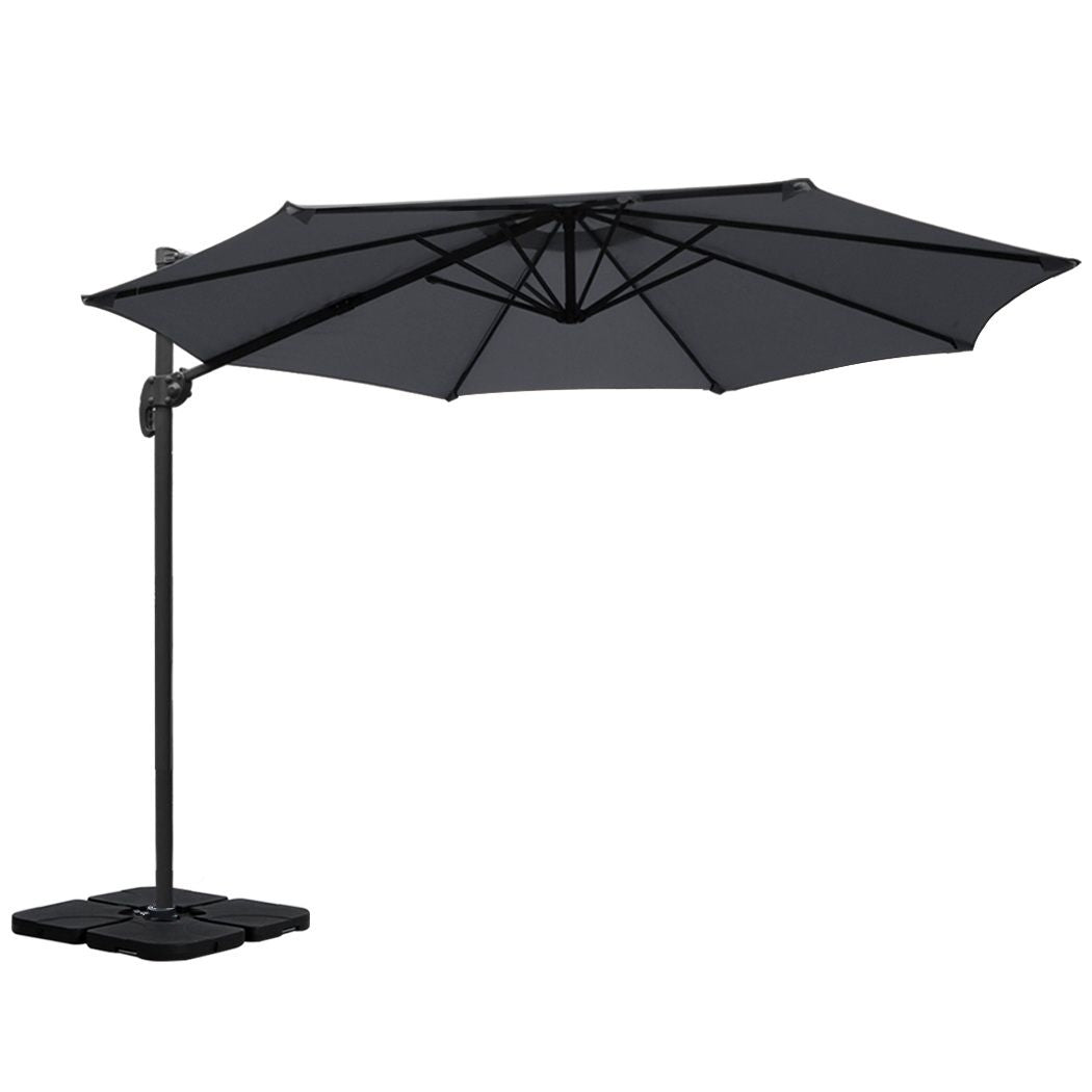 Charcoal cantilever patio umbrella with open canopy and central support pole with base