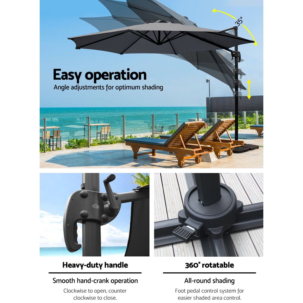 Charcoal cantilever umbrella canopy angled on a central pole with square weighted base