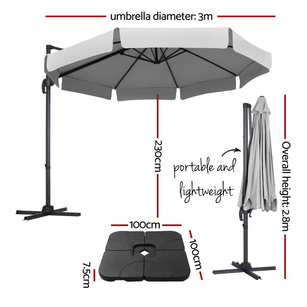 Light grey cantilever patio umbrella open with black pole and cross base