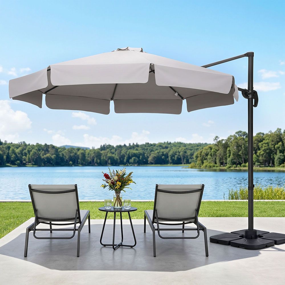 Cantilever patio umbrella with light grey canopy and black pole with weighted base