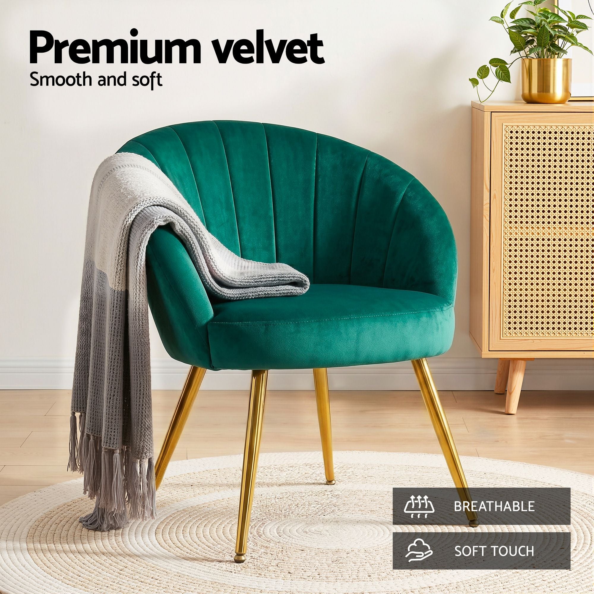 Green velvet armchair with curved back and padded seat, gold tapered legs