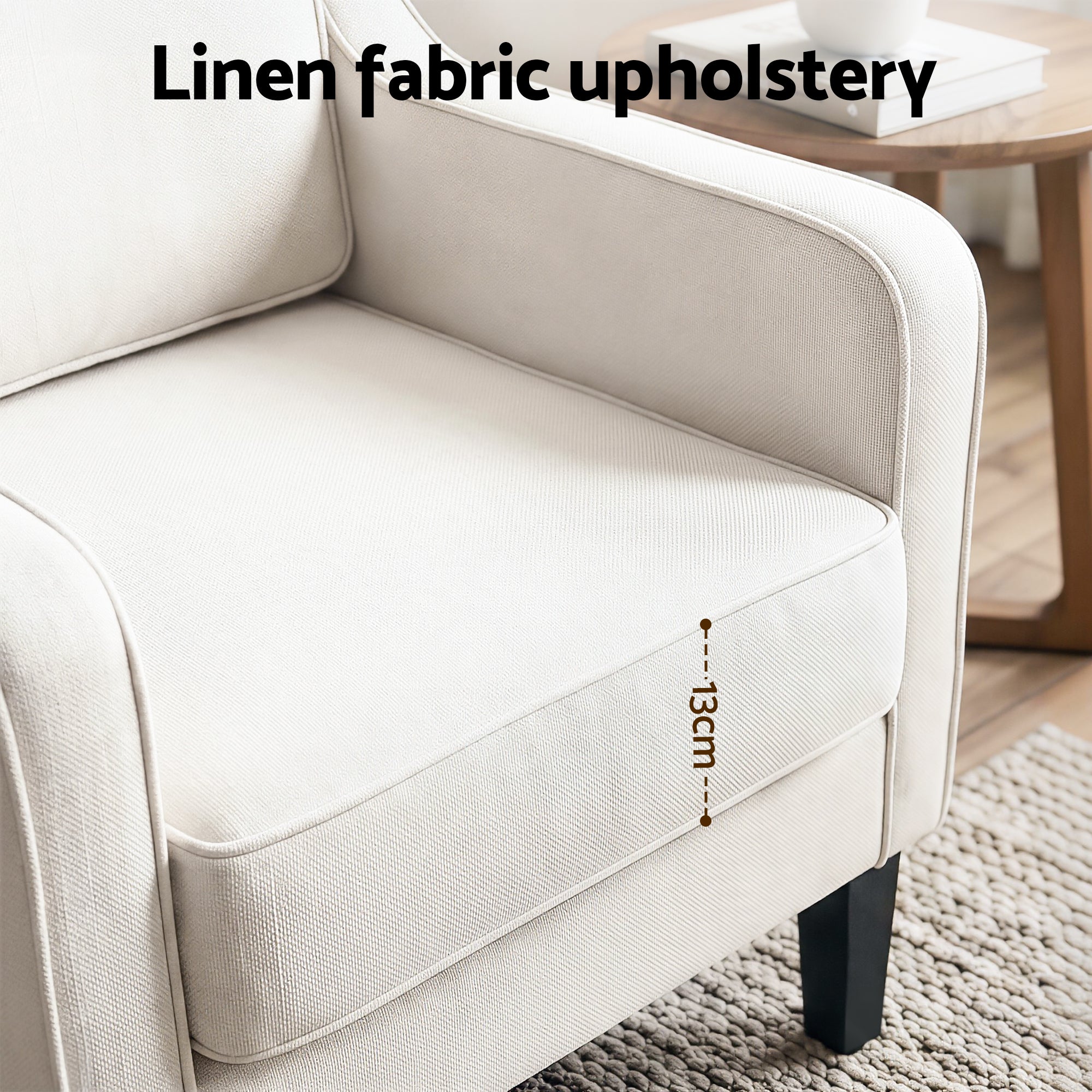 Light beige linen lounge chair with padded armrests and stitched seat panel detail