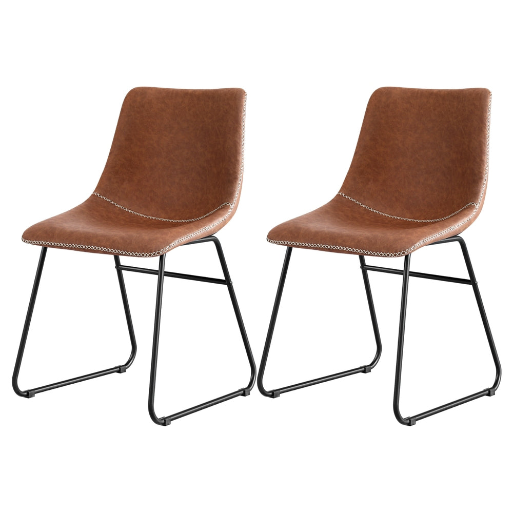 Pair of brown PU dining chairs, curved back, stitched seat, black sled legs