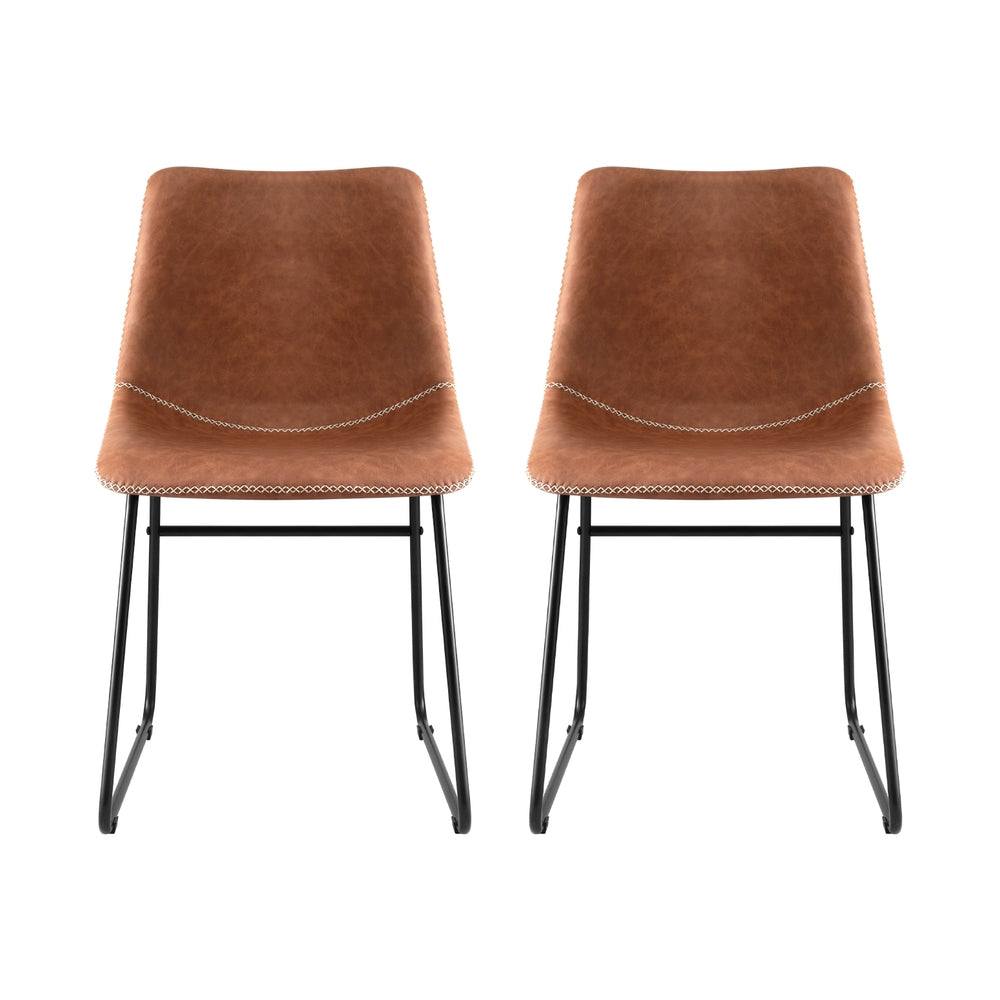 Pair of brown upholstered dining chairs with curved back and black sled frames