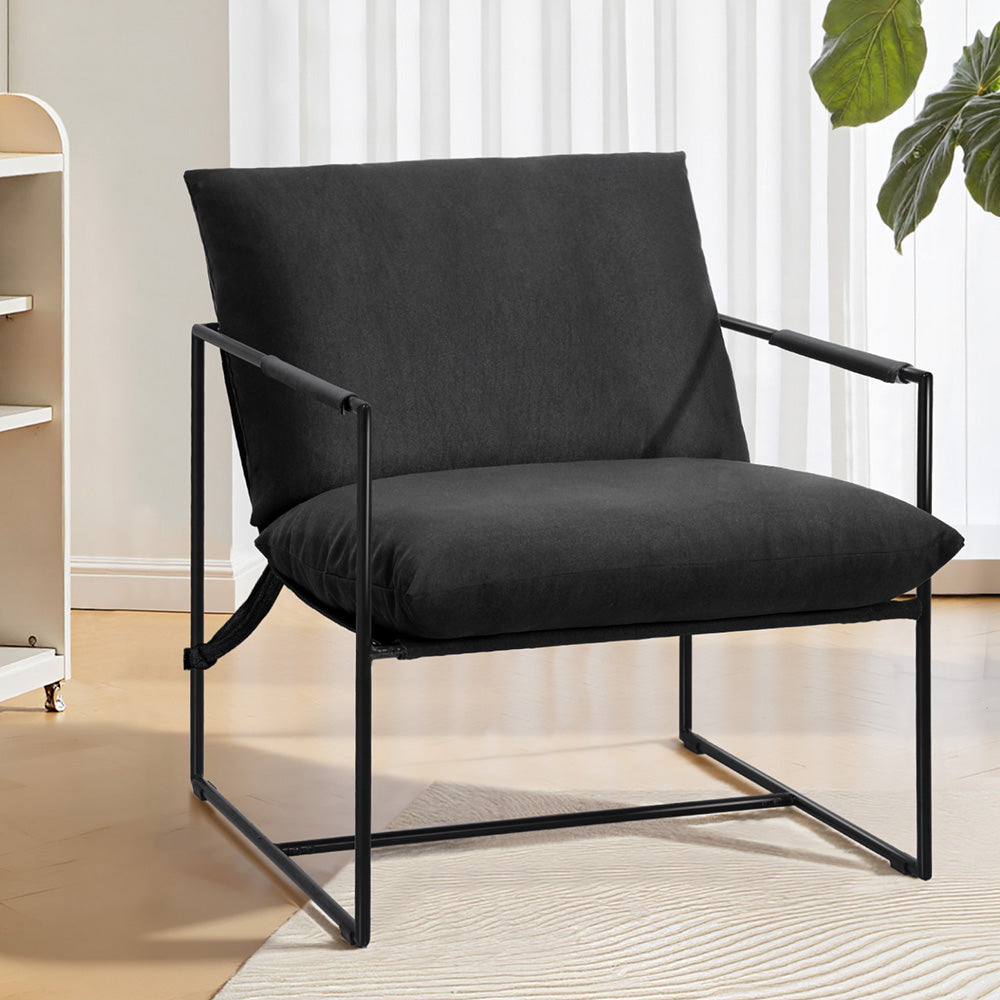 Black sling lounge chair with padded seat and backrest on black metal frame