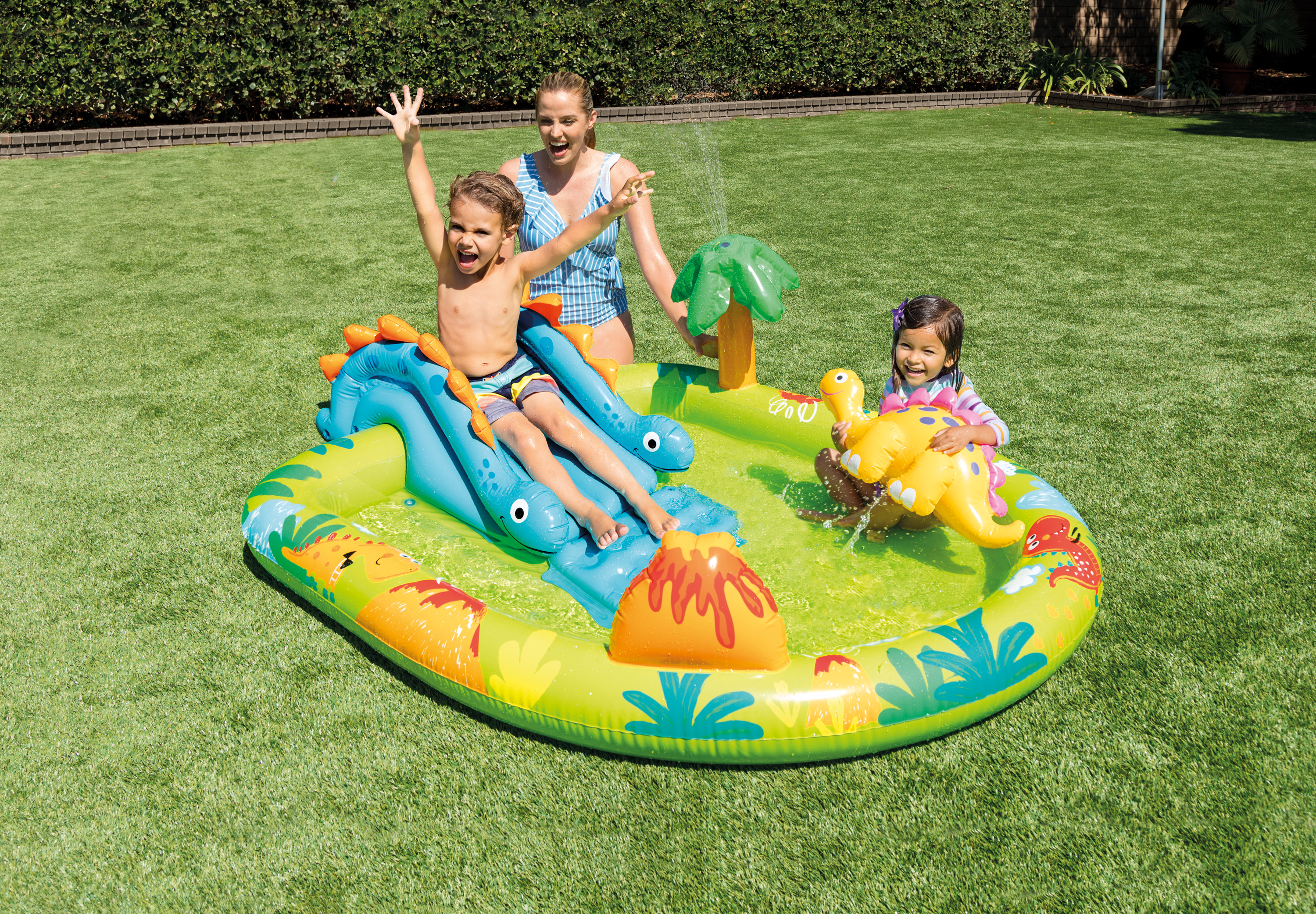 Dinosaur-themed inflatable play centre with slide, blue base and orange accents