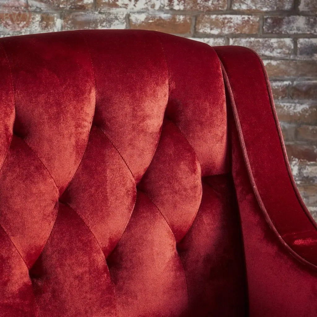 Tufted velvet armchair backrest detail with deep red button tufting