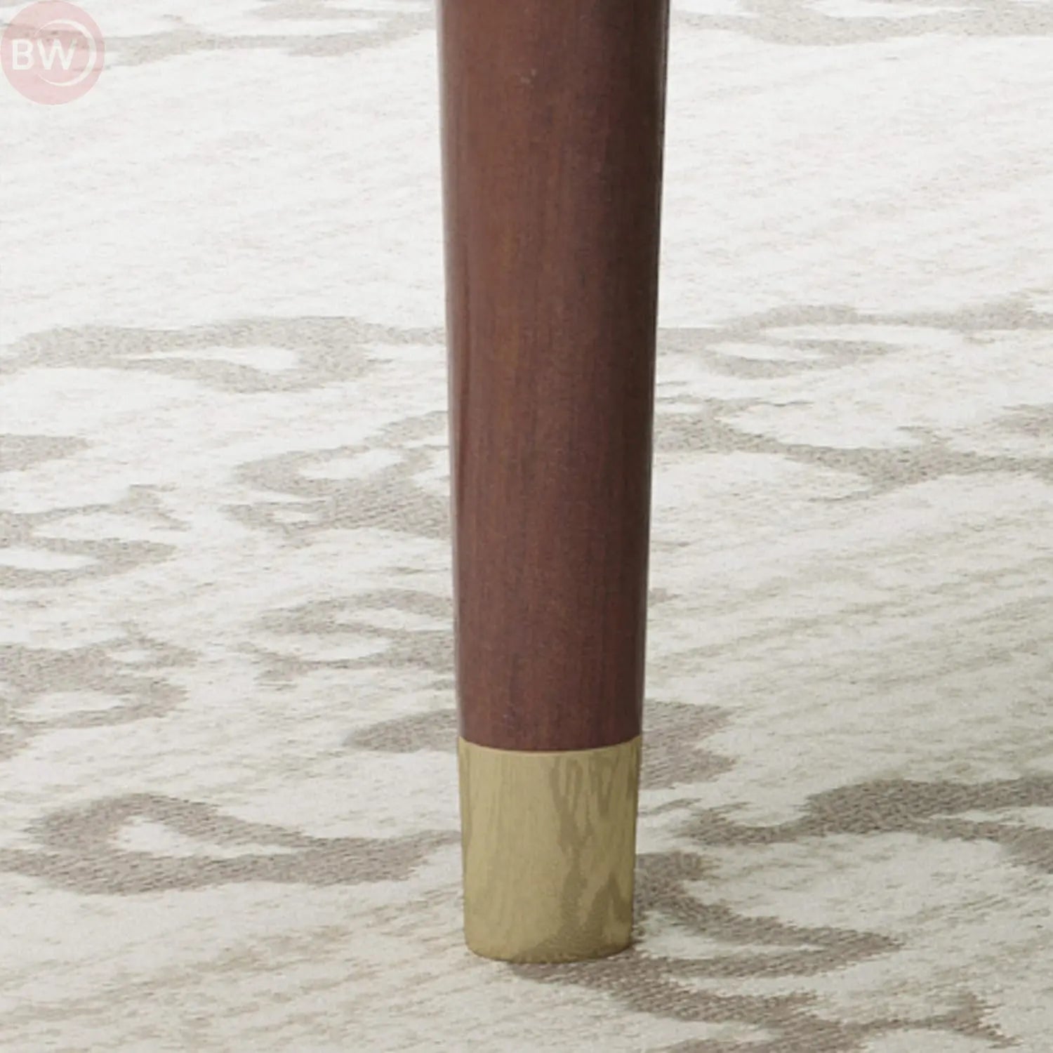 Black tufted velvet armchair legs with gold-toned caps
