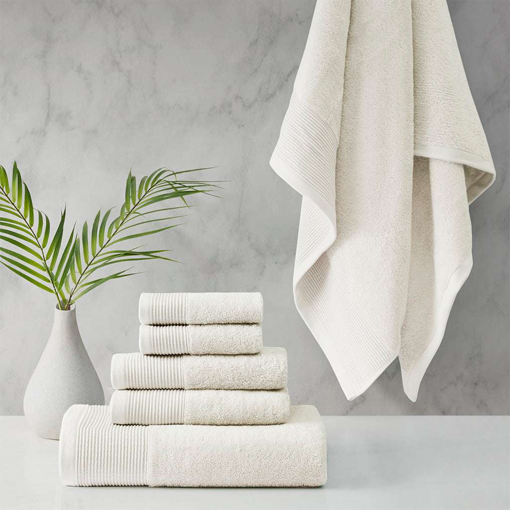 Retreat Cotton Tencel Antimicrobial 6 Piece Ivory Towel Set by Cloud Linen on display in a bathroom setting.