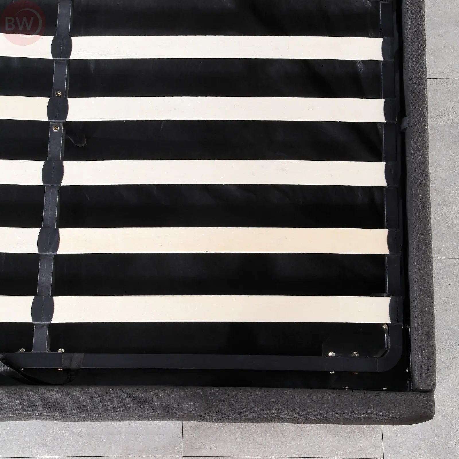 Dark grey bed base close-up with slat support bars and lift brackets