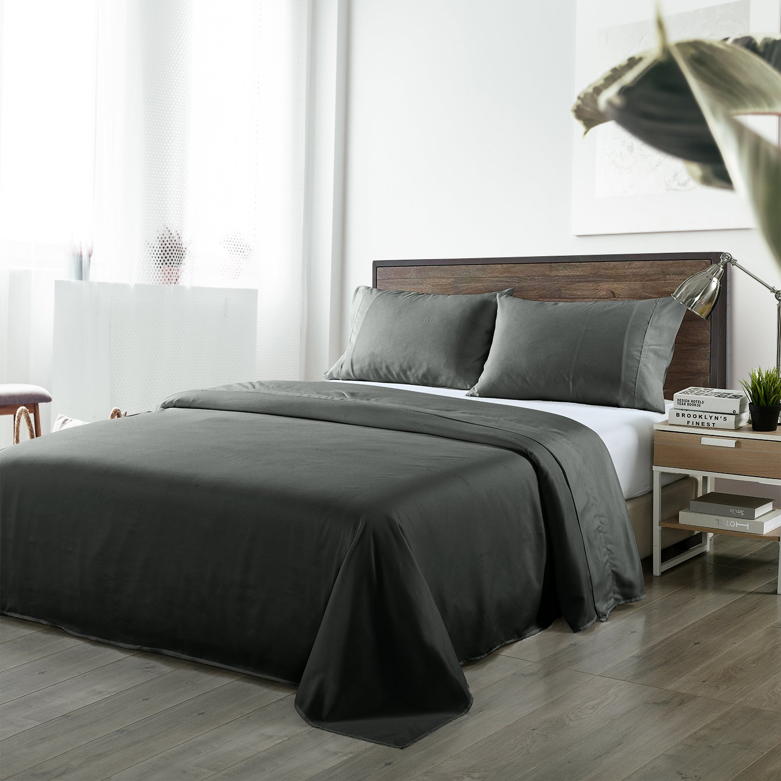 Charcoal king sheet set with matching pillowcases on a bed