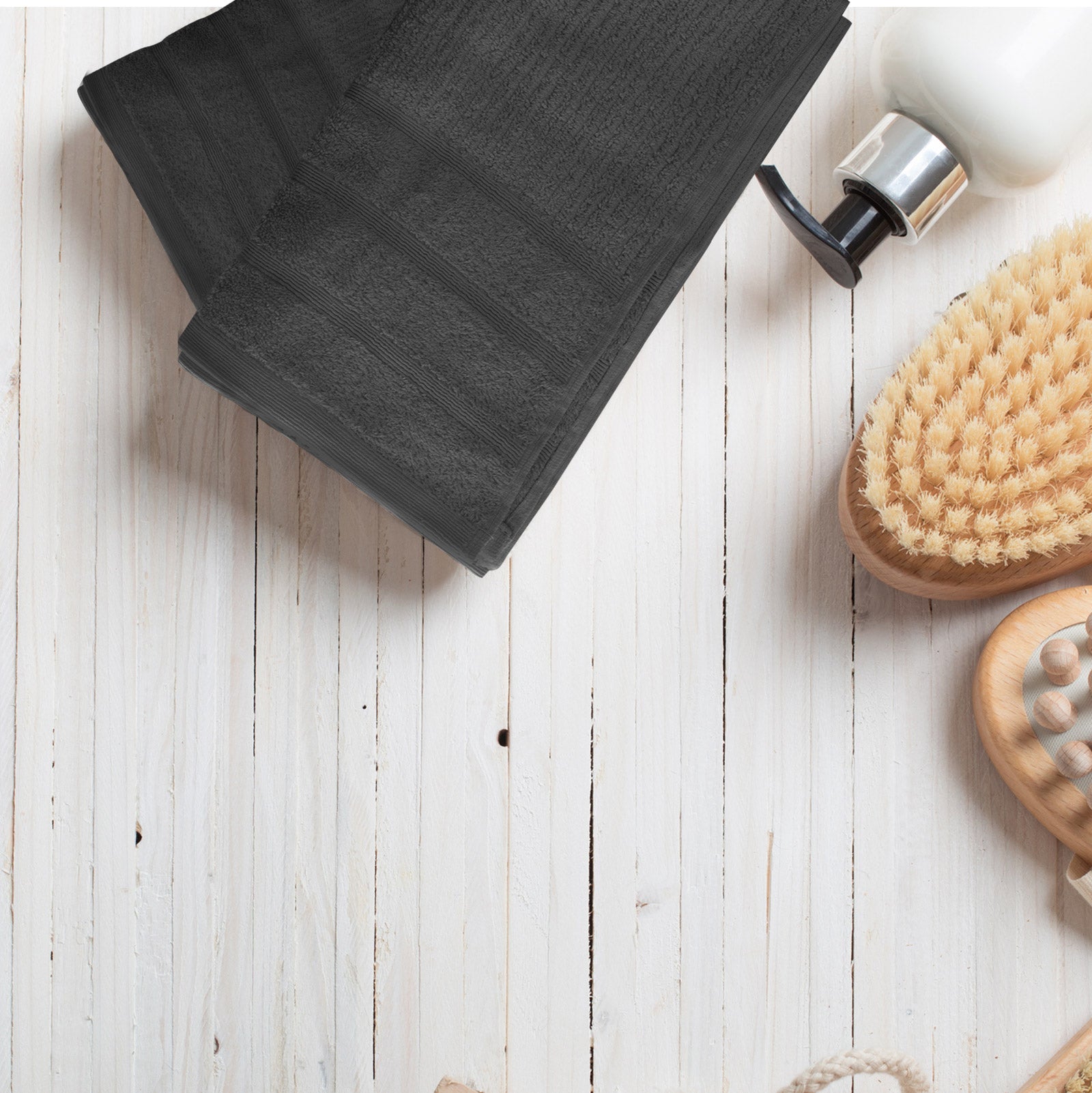 Folded bath towels, dark gray terry cloth with woven corner trim