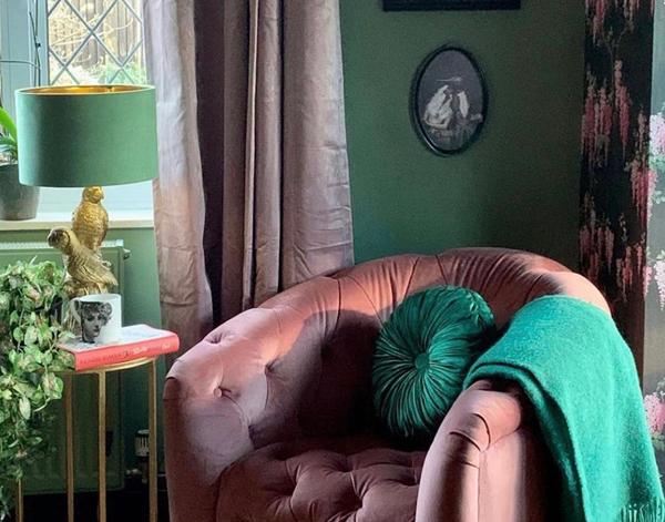 Emerald wool throw draped over armchair with textured knit and fringed edge