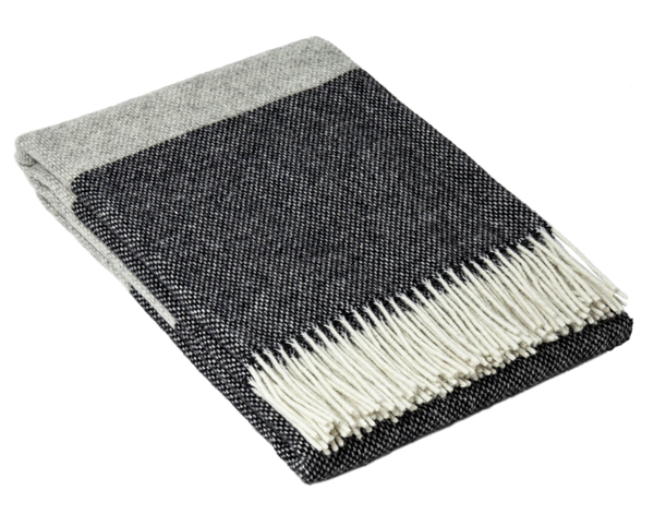 Monochrome wool throw blanket with dark knit face, light reverse, fringed edges
