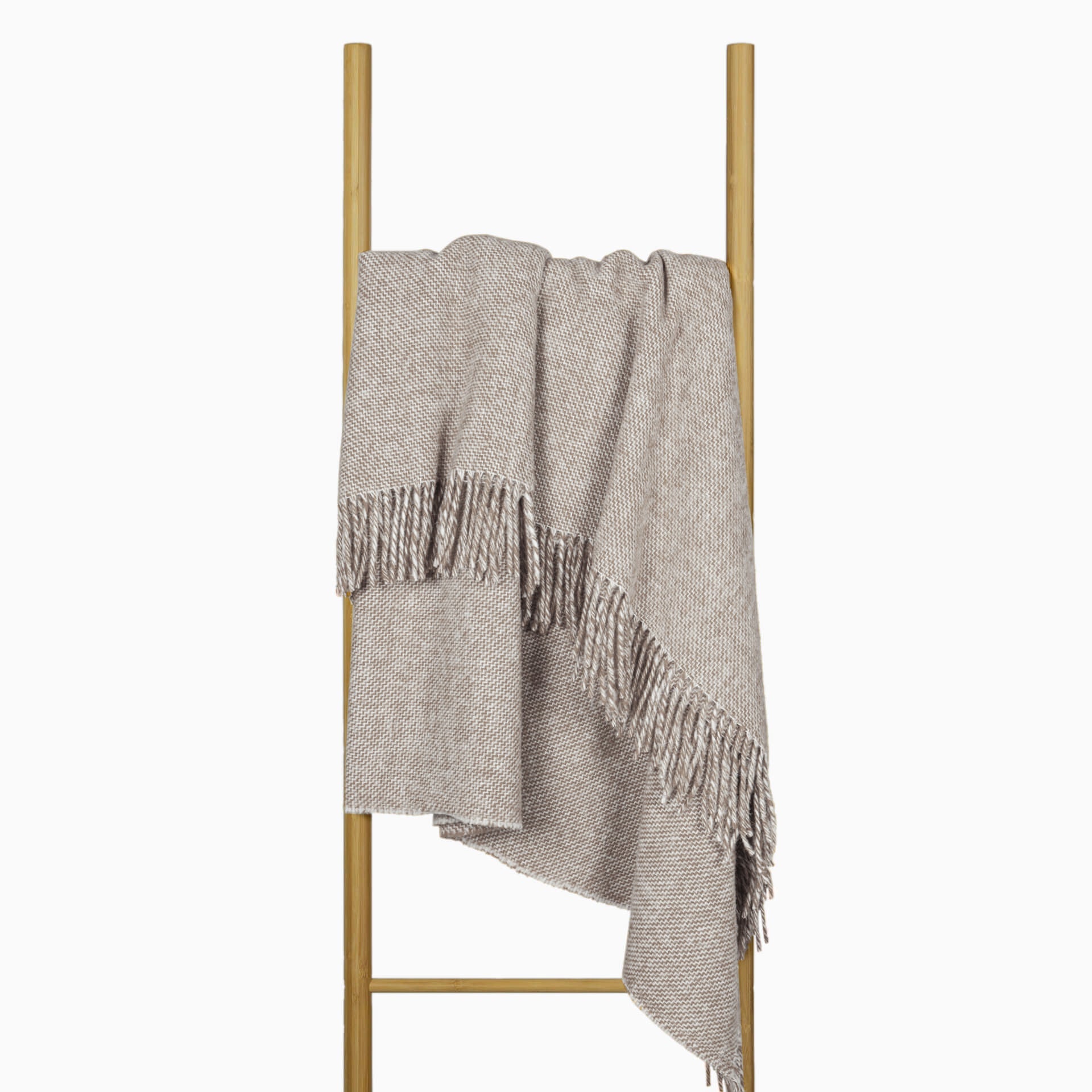 Cambridge wool throw draped on stand, silver herringbone weave with fringed ends