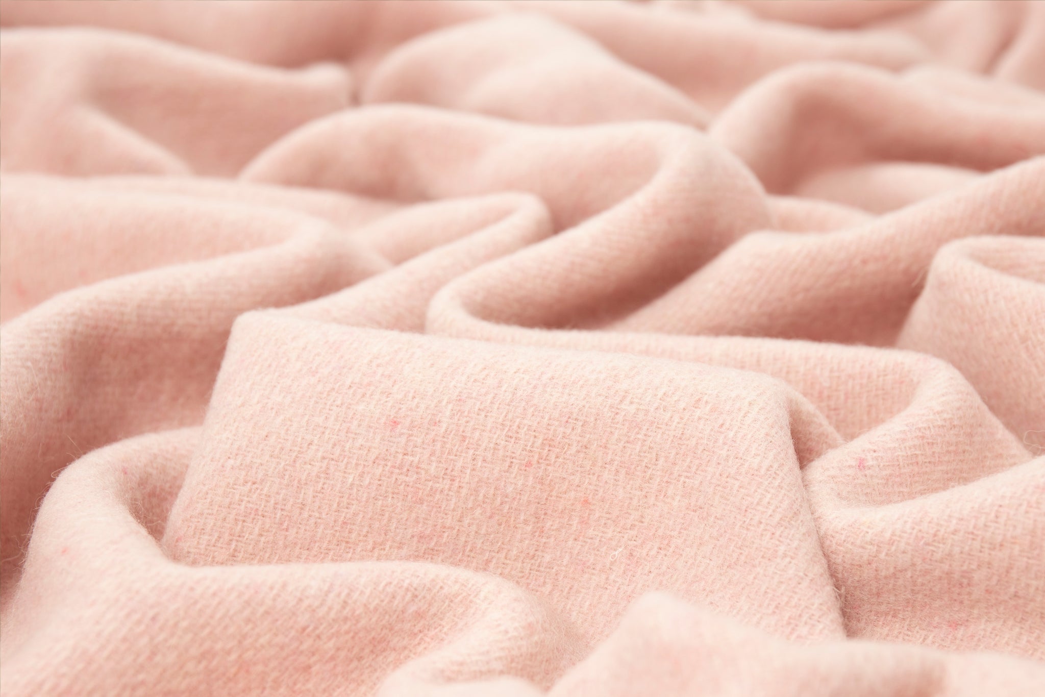 Blush wool blend throw blanket with soft knit texture close-up