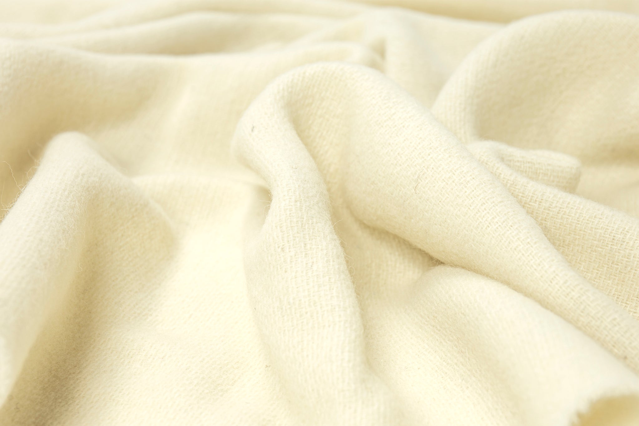 Ivory knit merino wool blend throw blanket, textured fabric close-up