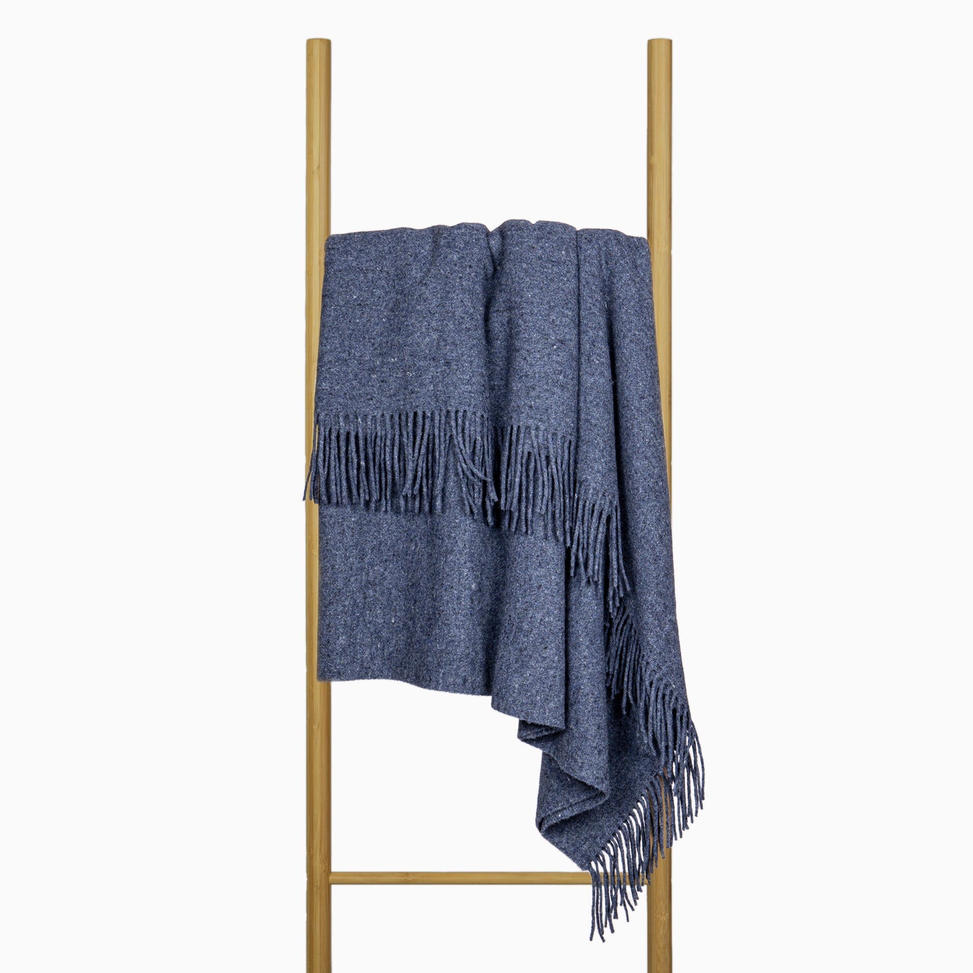 Navy wool-blend throw blanket draped over a stand with fringed border.