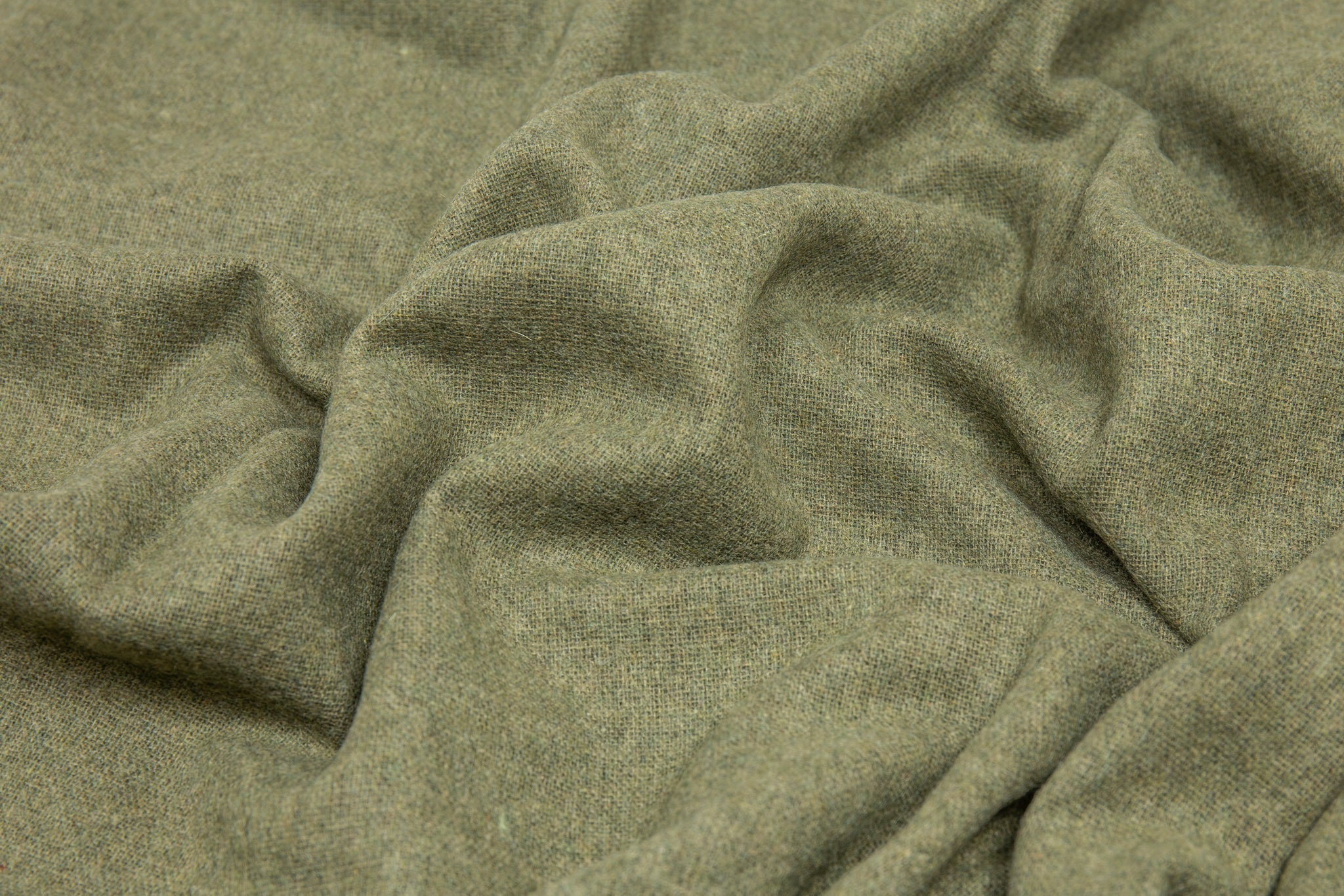 Olive wool-blend throw fabric close-up with soft woven texture