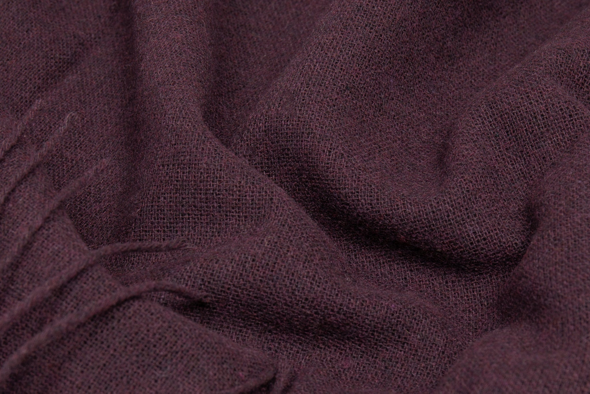 Plum wool-blend throw fabric close-up with soft woven texture
