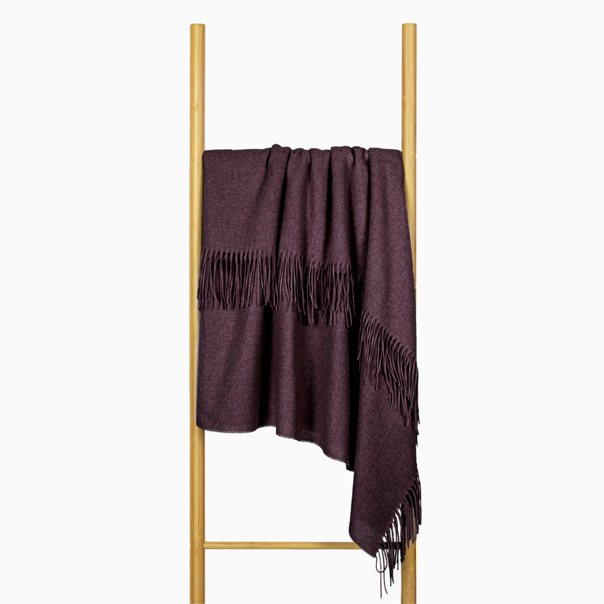 Plum wool-blend throw draped on stand with gathered edge and fringe