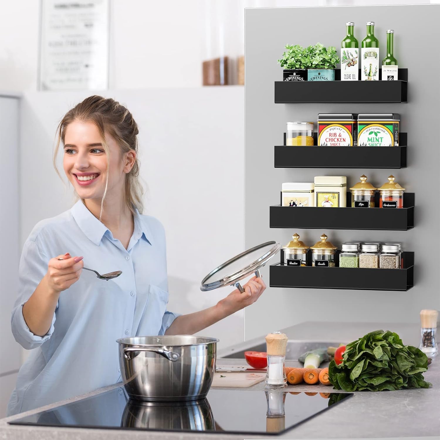 Black magnetic fridge spice rack with four tiers of spice containers, jars, and bottles