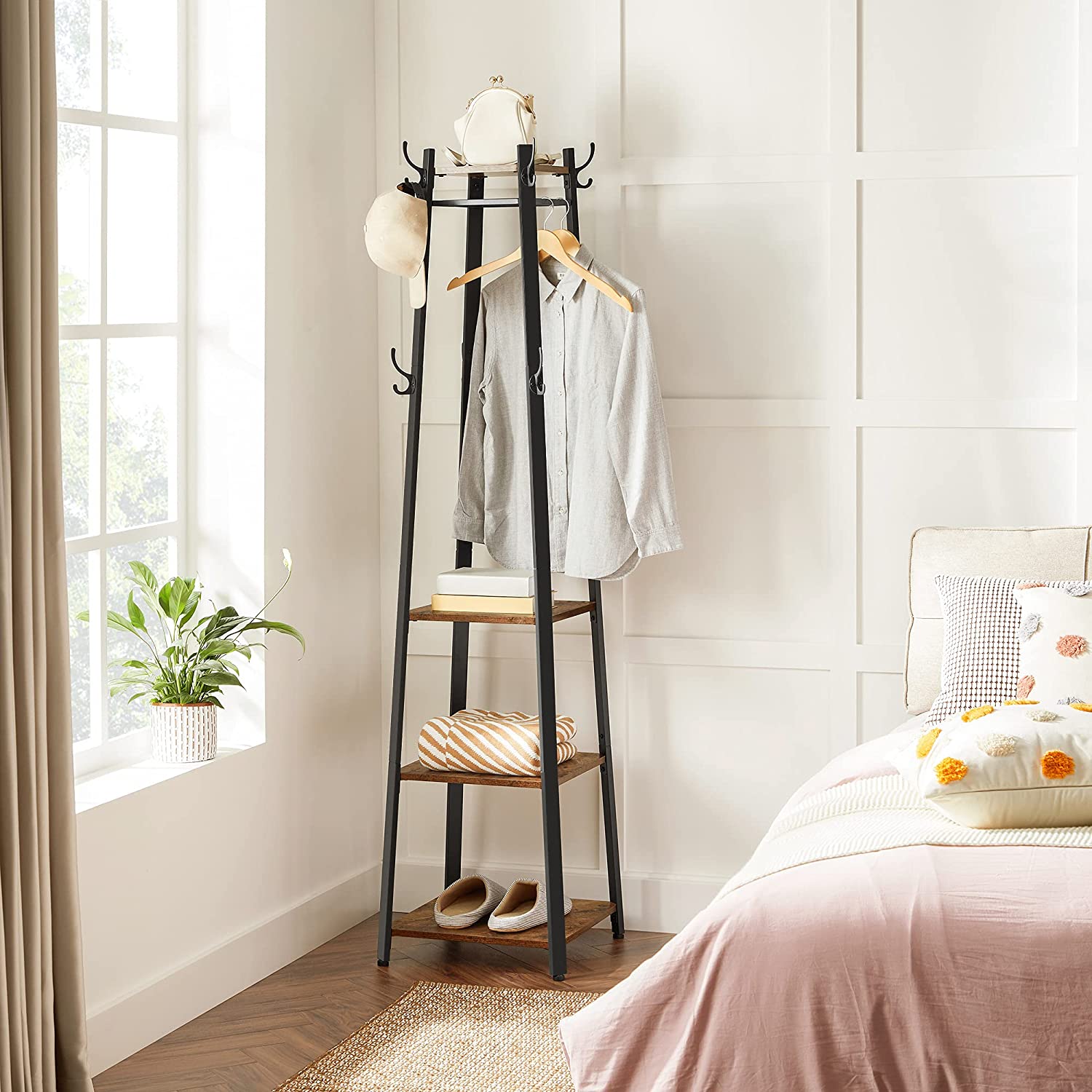 Coat rack with 3 shelves and hooks holding shirts and accessories.