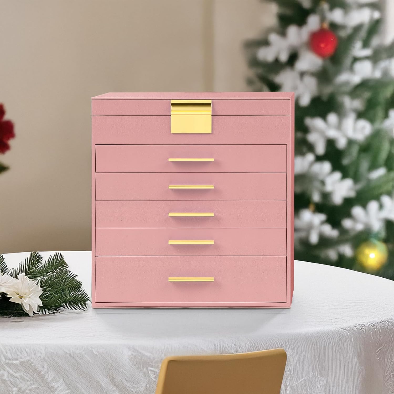 Pink jewelry organizer cabinet with stacked drawers and gold-tone handles