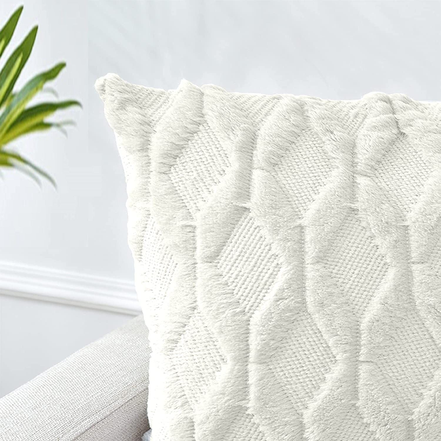 White pillow cover with quilted diamond pattern, corner and edge close-up