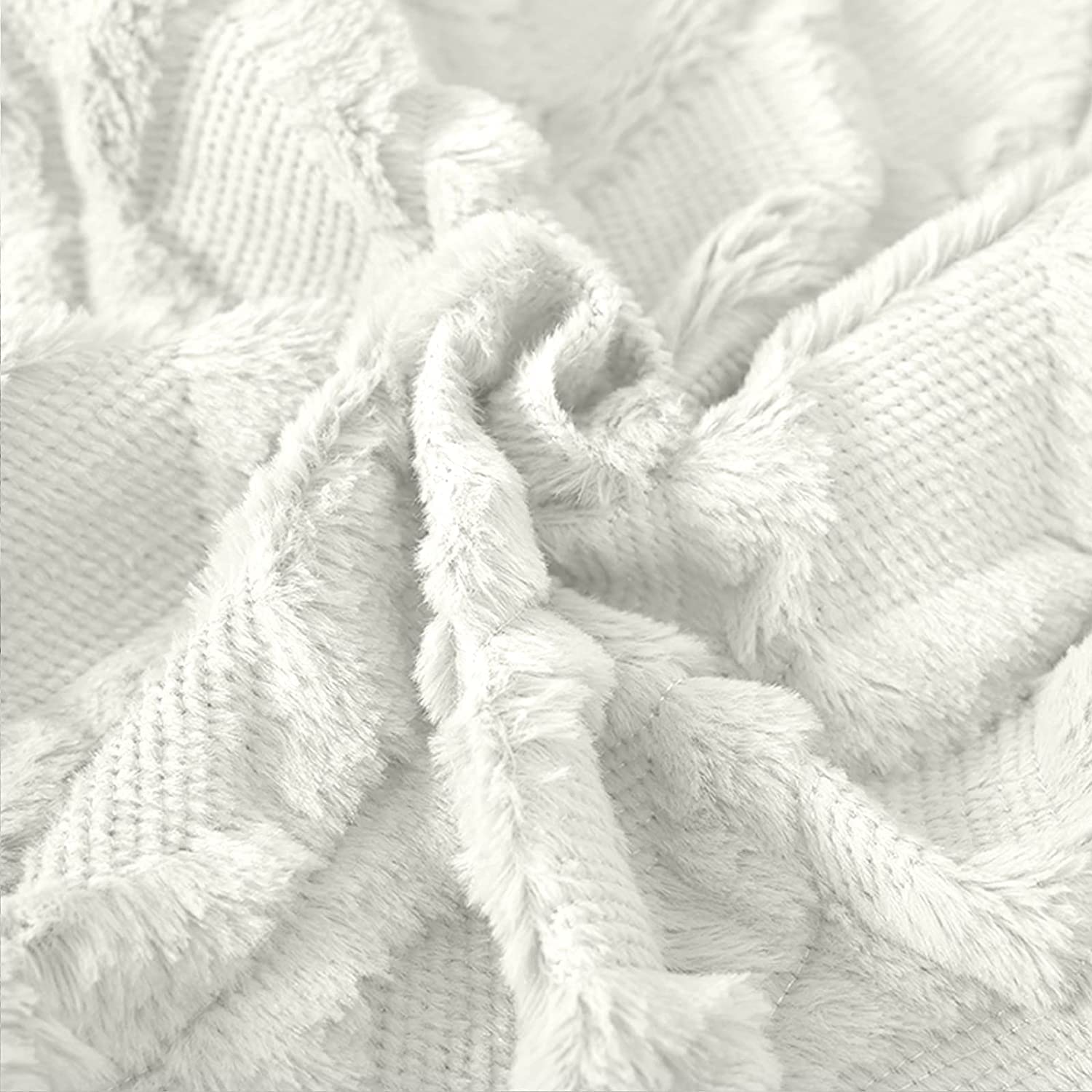 White pillow cover with tassel fringe trim and raised diamond quilt texture
