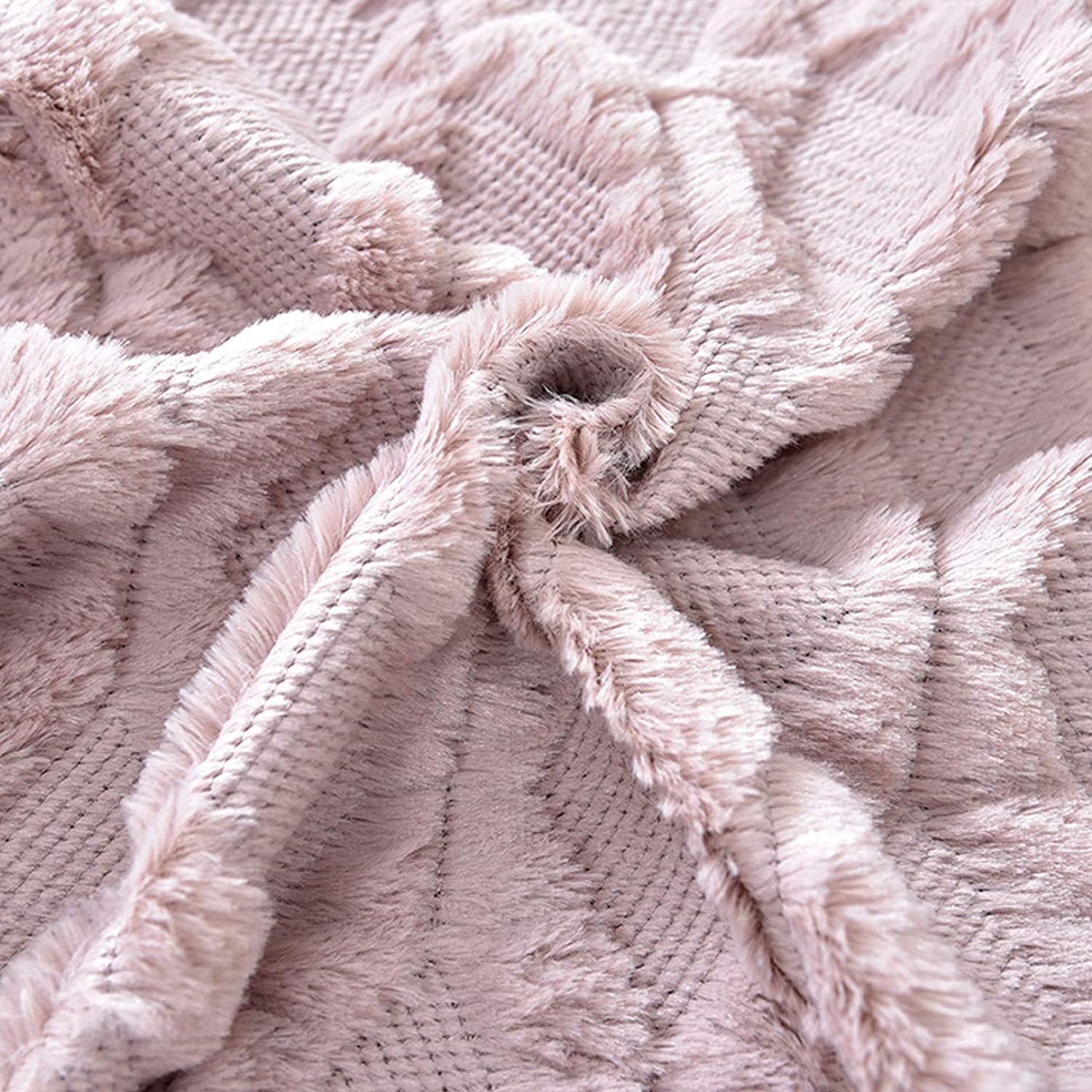 Pink pillow cover with knotted tassel fringe detail over textured weave