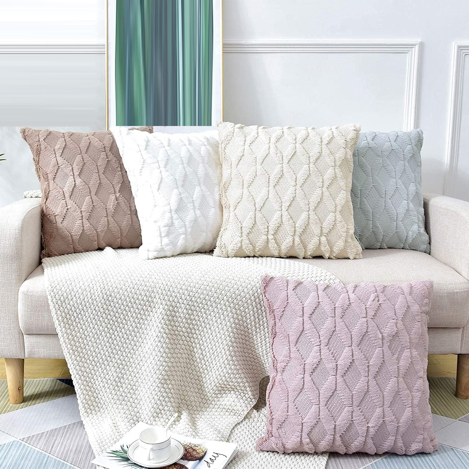 Set of textured diamond pillow covers in cream, white, light blue, and mauve