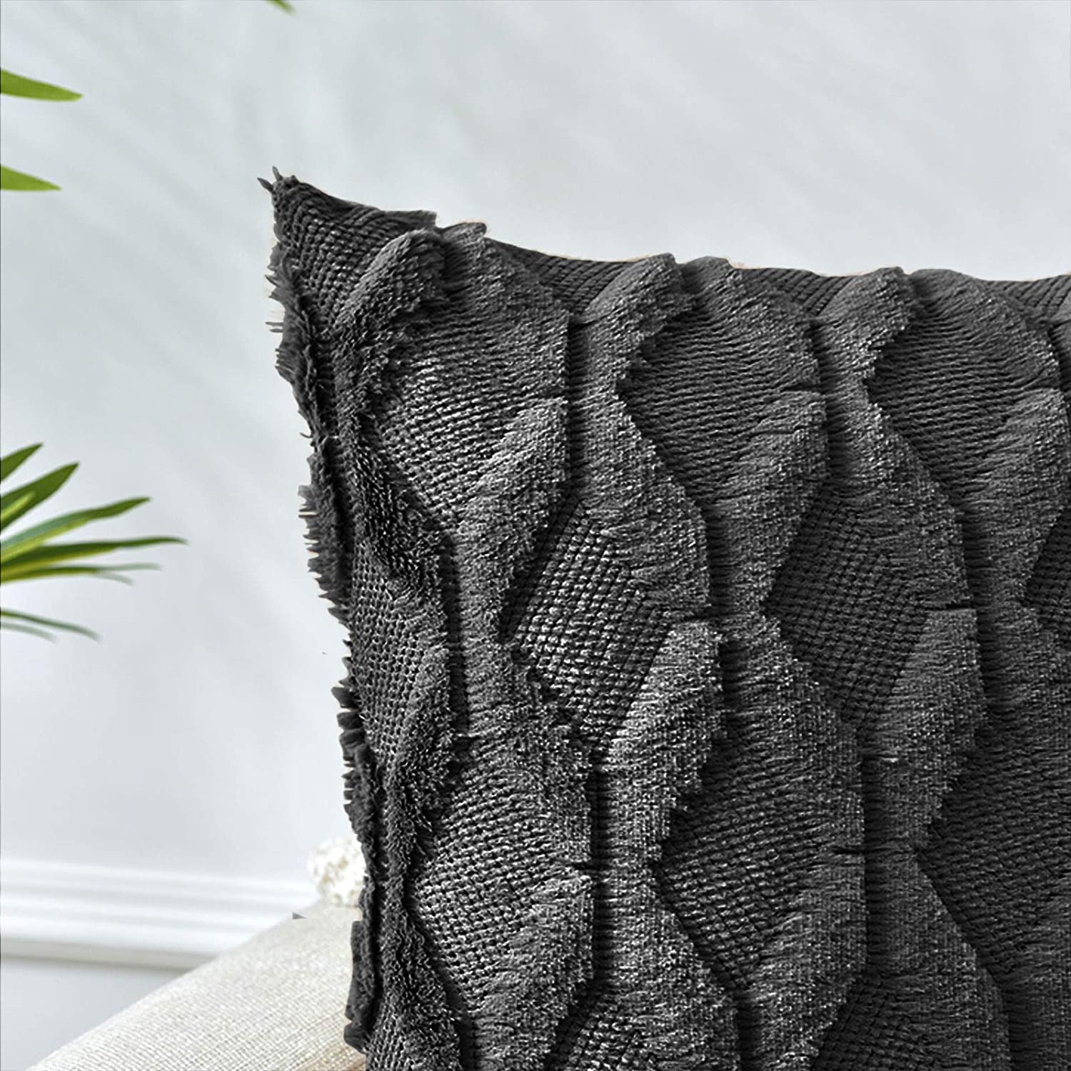 Black boho pillow cover with raised diamond pattern and fringed trim