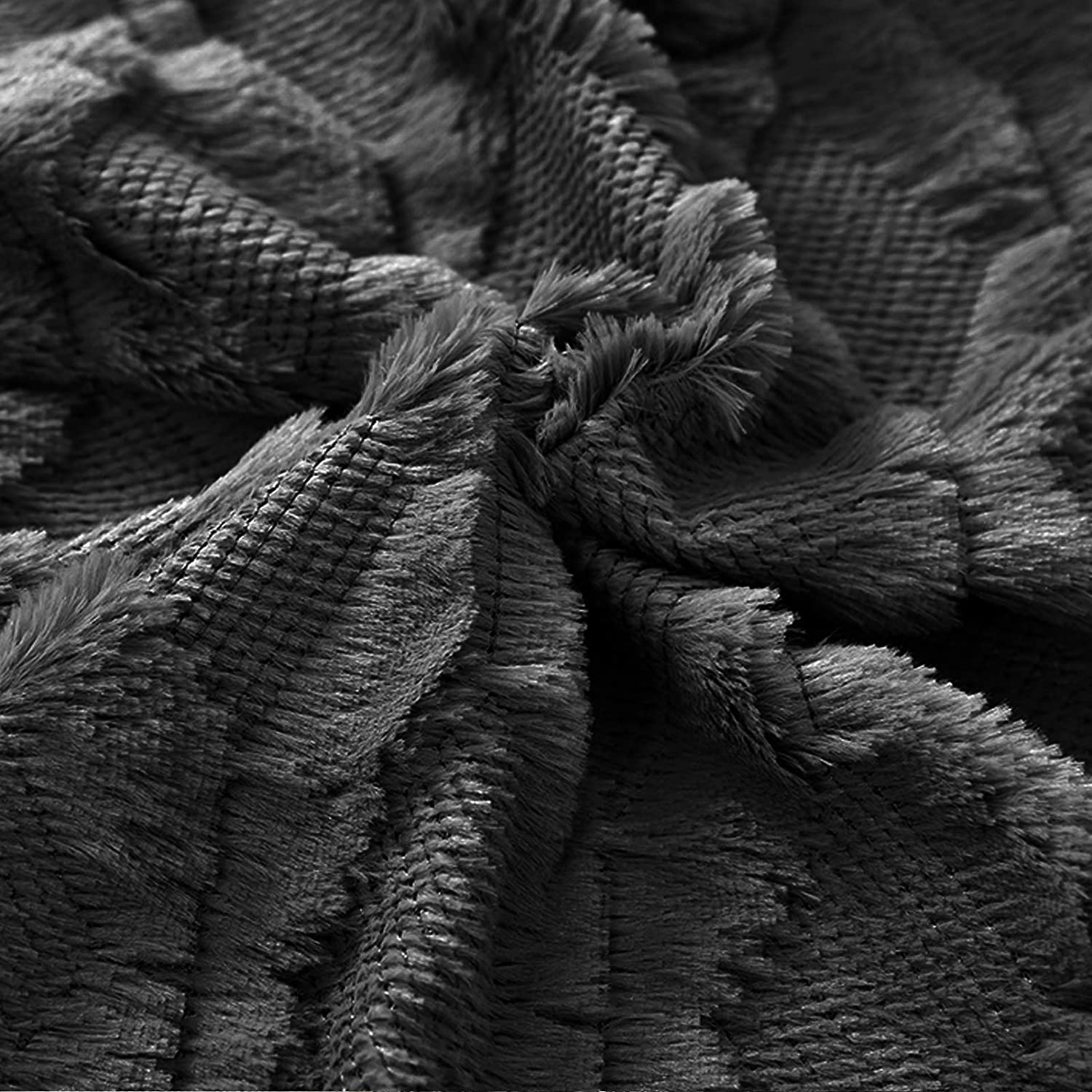 Black pillow cover close-up of woven diamond texture and soft tassels