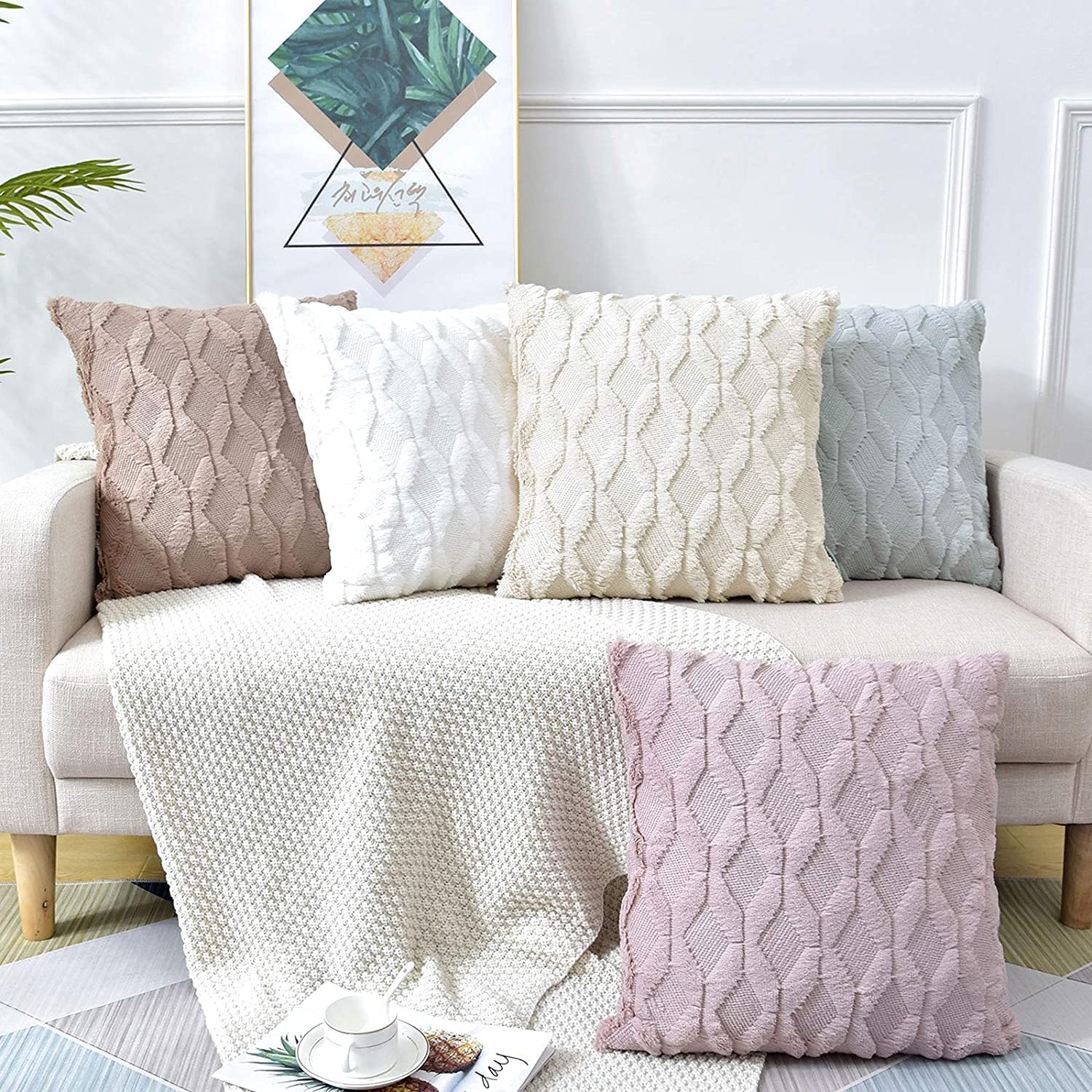 Set of decorative boho pillow covers with textured diamond pattern in light tones