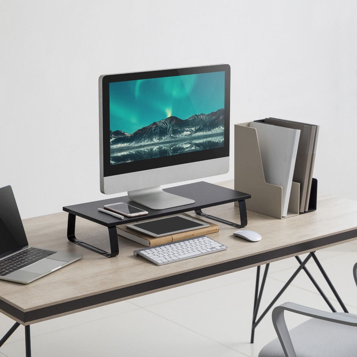 Black monitor stand riser side view with textured top and curved metal support