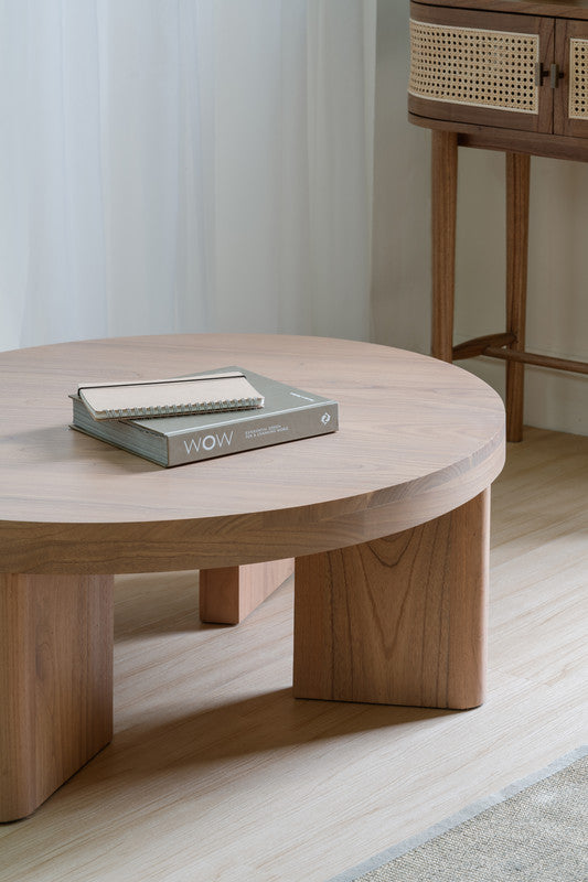 Natural wood round coffee table with visible grain top and short block legs
