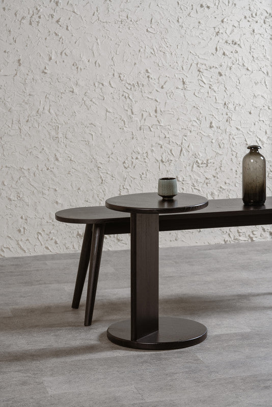 Black round solid timber lamp table with two-tier pedestal base and circular top