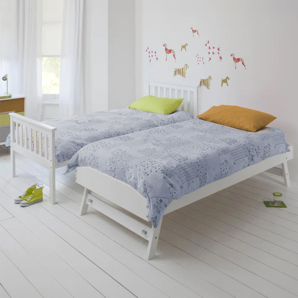 White wooden single bed frame with headboard and guard rails, with pillows