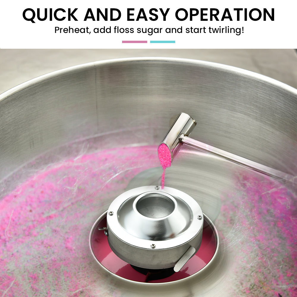 Cotton candy machine head dispensing pink sugar floss into stainless steel bowl