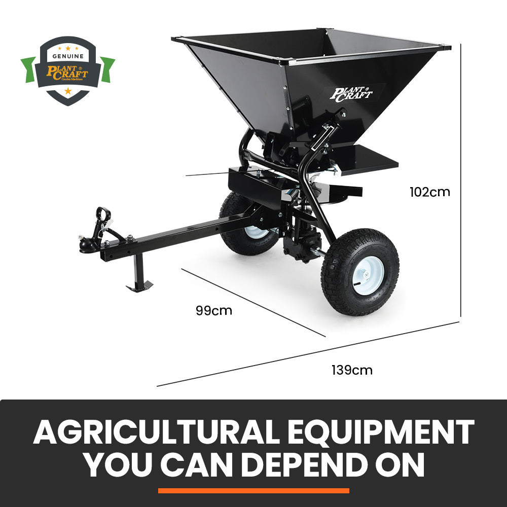 Tow-behind broadcast spreader with black hopper, tow frame, and front two wheels