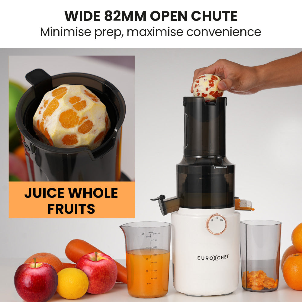 White cold press slow juicer with wide chute, whole fruit and juice cups shown