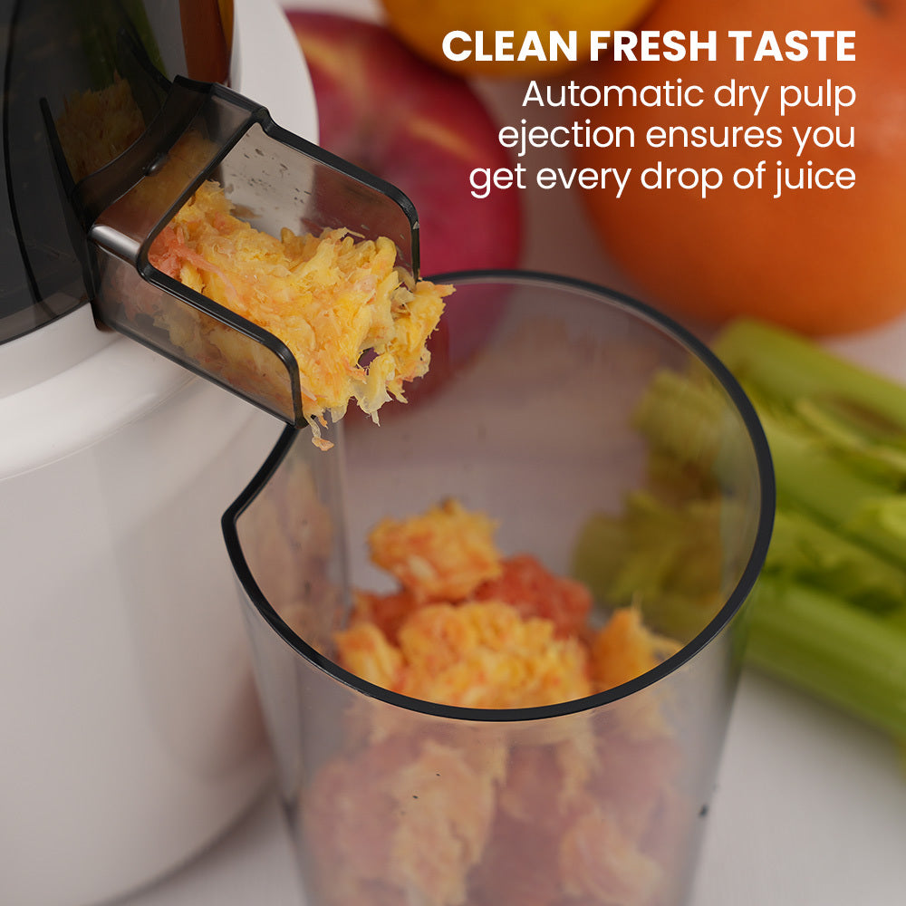 Cold press slow juicer feeding chute with pulp ejecting into a clear container