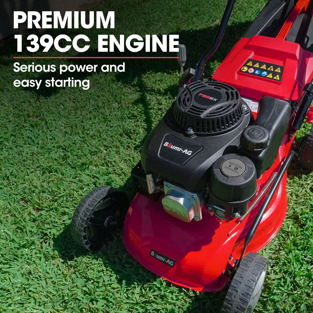 Red petrol push lawn mower with close-up of black engine and front cutting deck