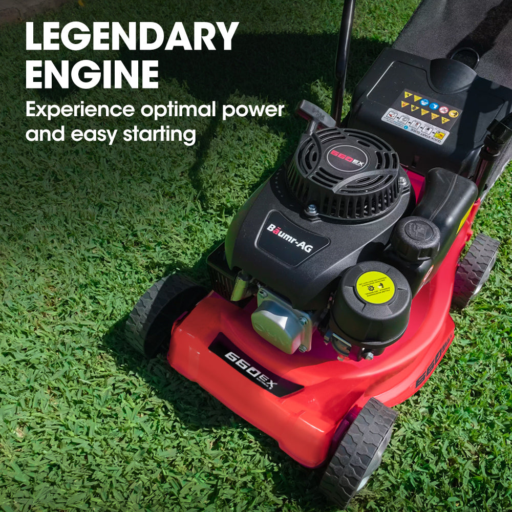 Petrol lawn mower with exposed engine and red deck, black air-intake housing.