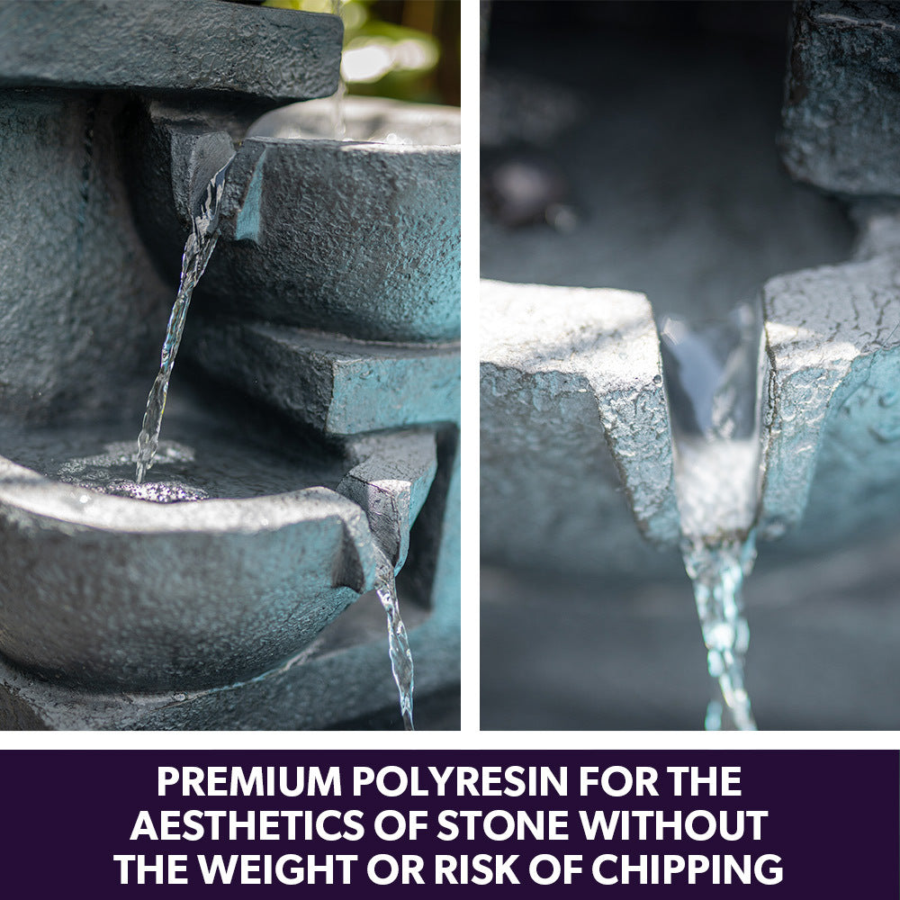 Charcoal resin water fountain close-up with cascading stream over textured bowls