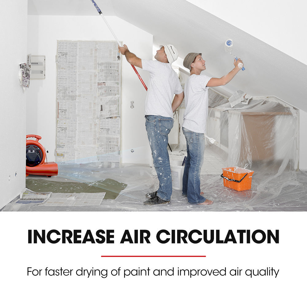 Red carpet air mover blower fan running in an empty room near taped drywall work