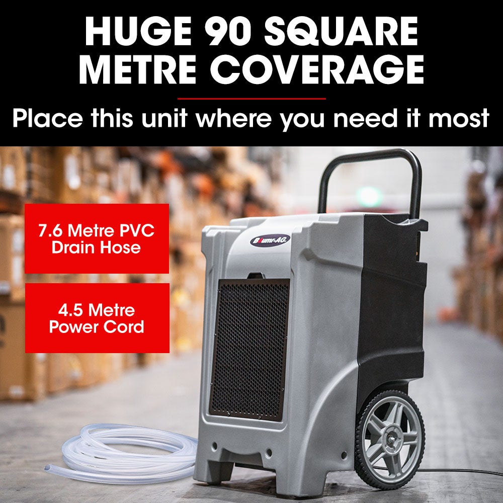 Portable dehumidifier with front grille, top handle, caster wheels, and coiled drain hose